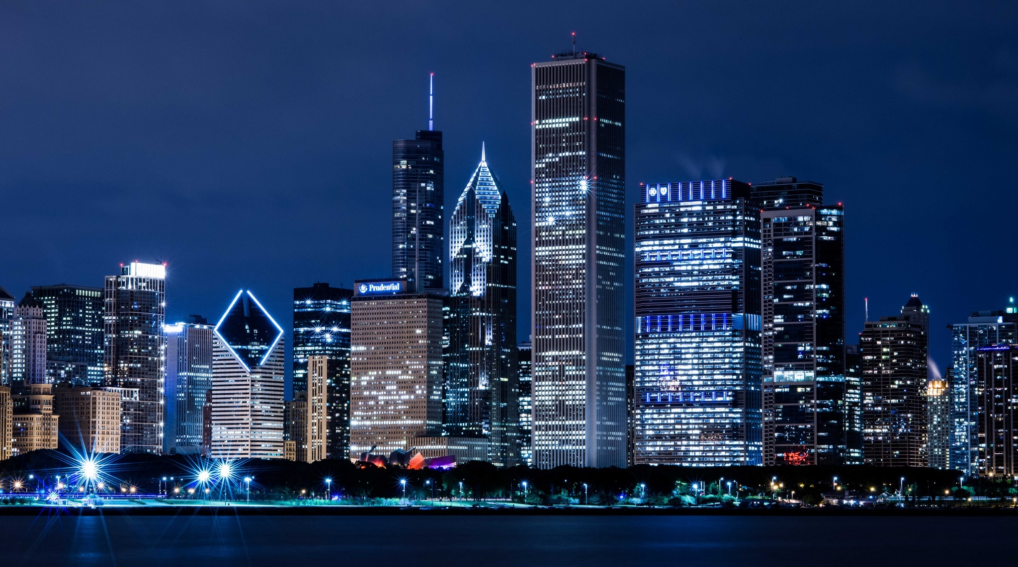 The Chicago skyline at night with a dark blue sky.